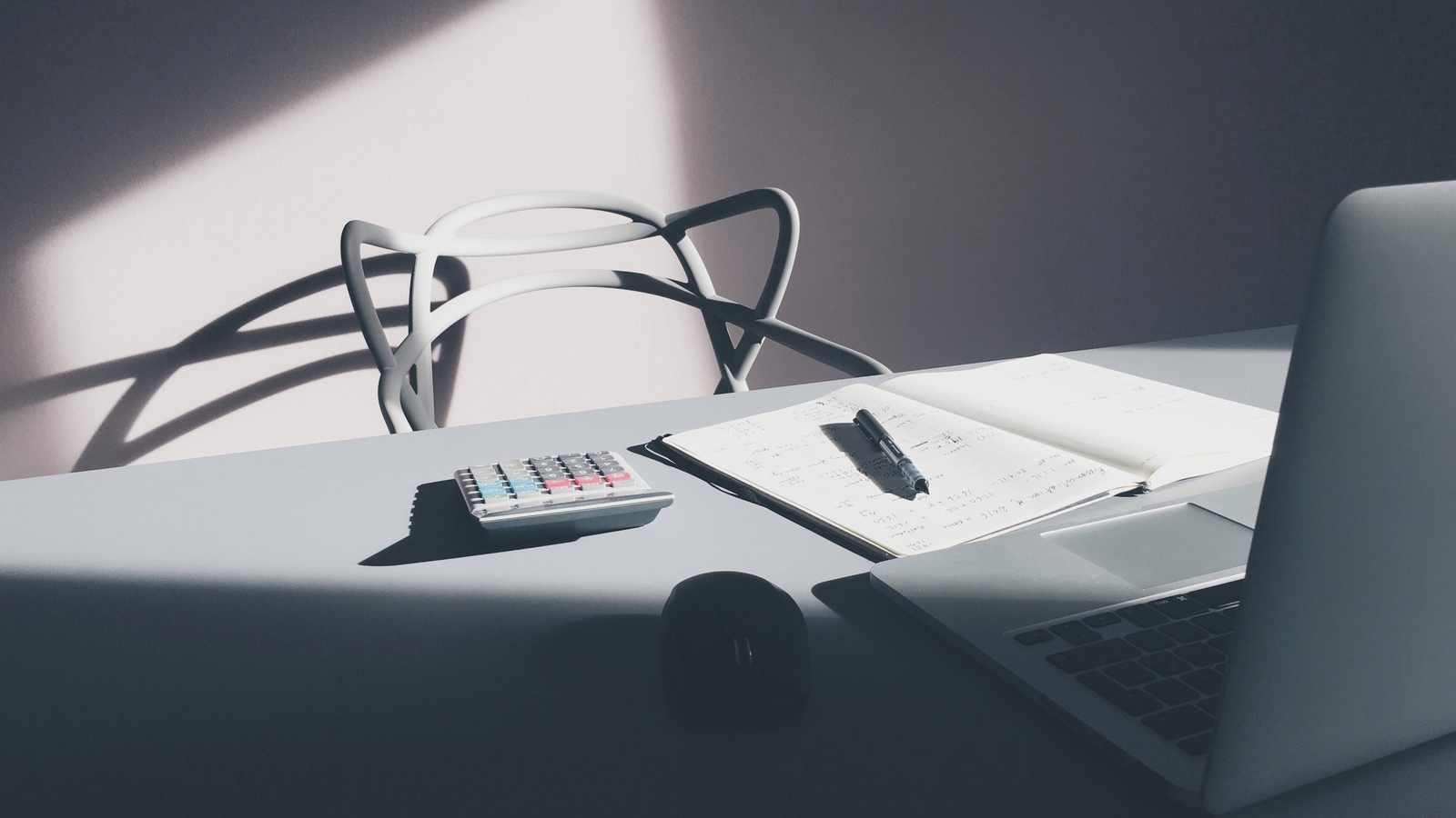 Laptop and calculator on a desk representing provider-controlled business context
