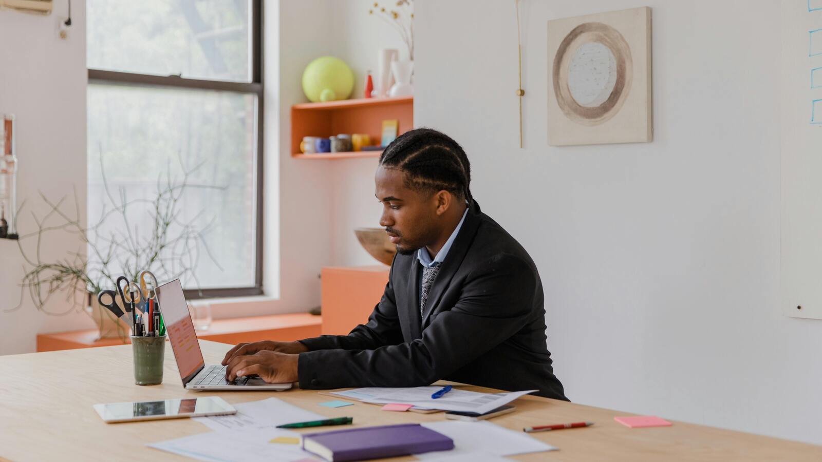 Person working on a laptop in an office, representing unmanaged agent installs on employee machines