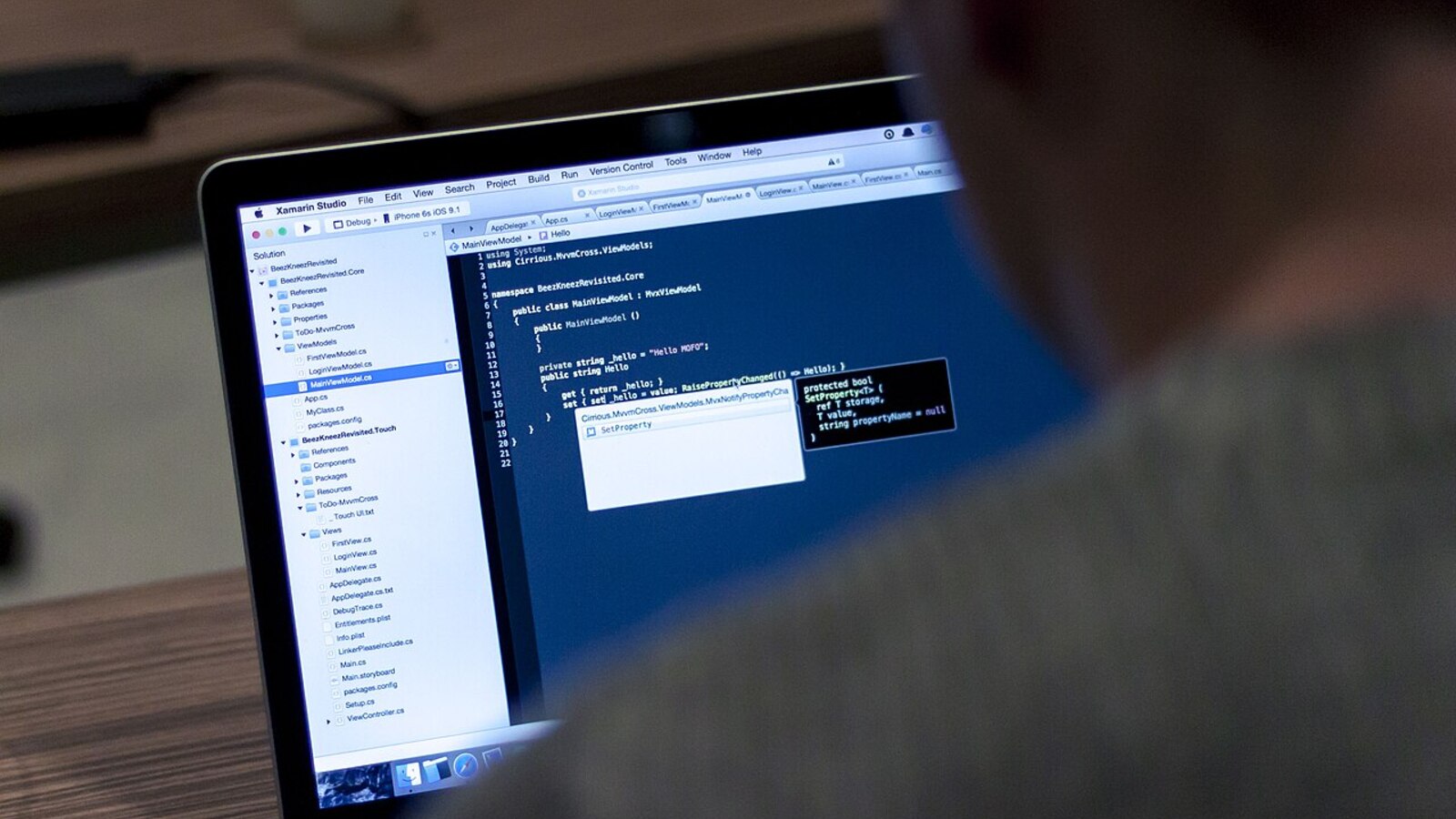 Laptop displaying source code in a development workspace